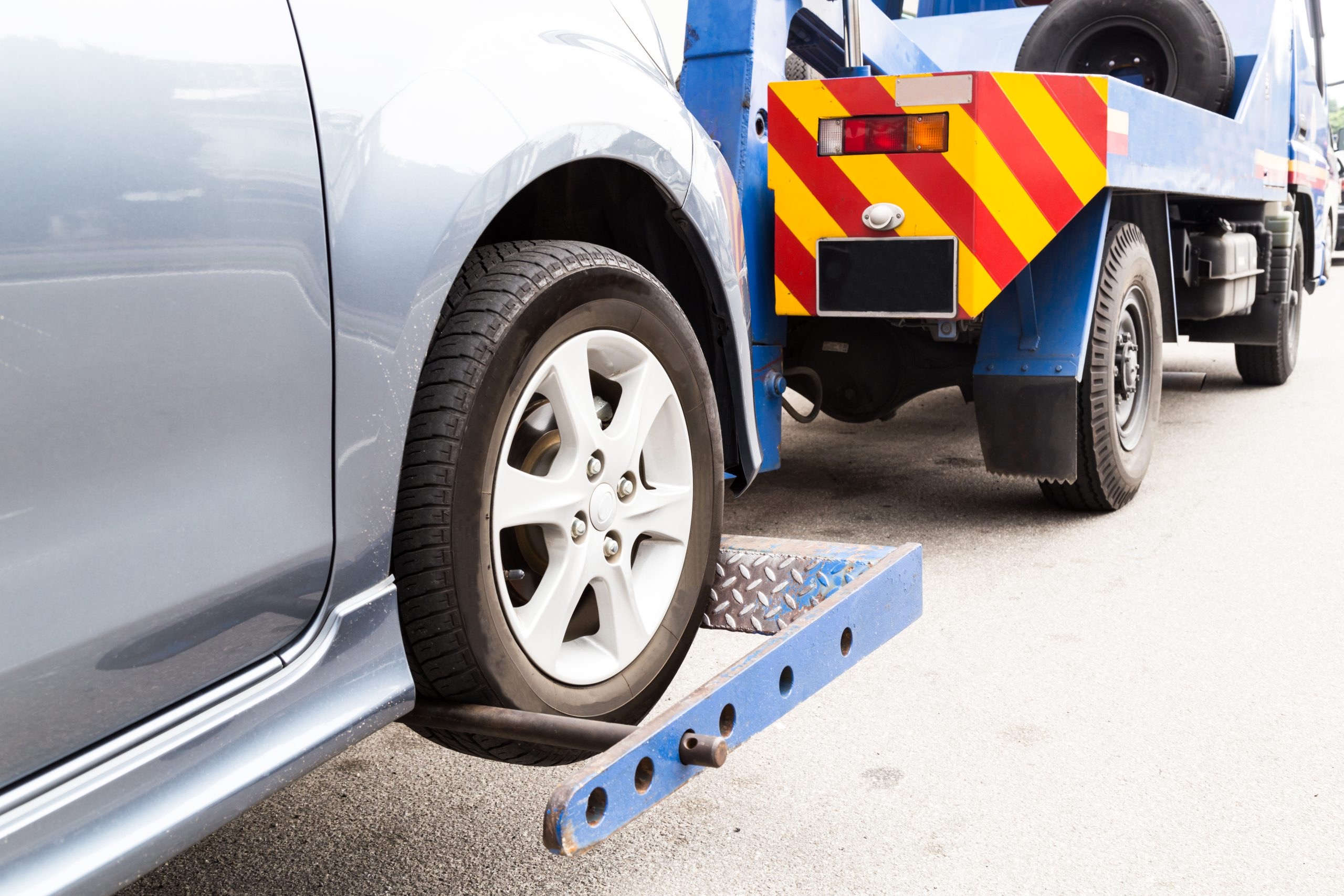 Car being collected by pickup truck